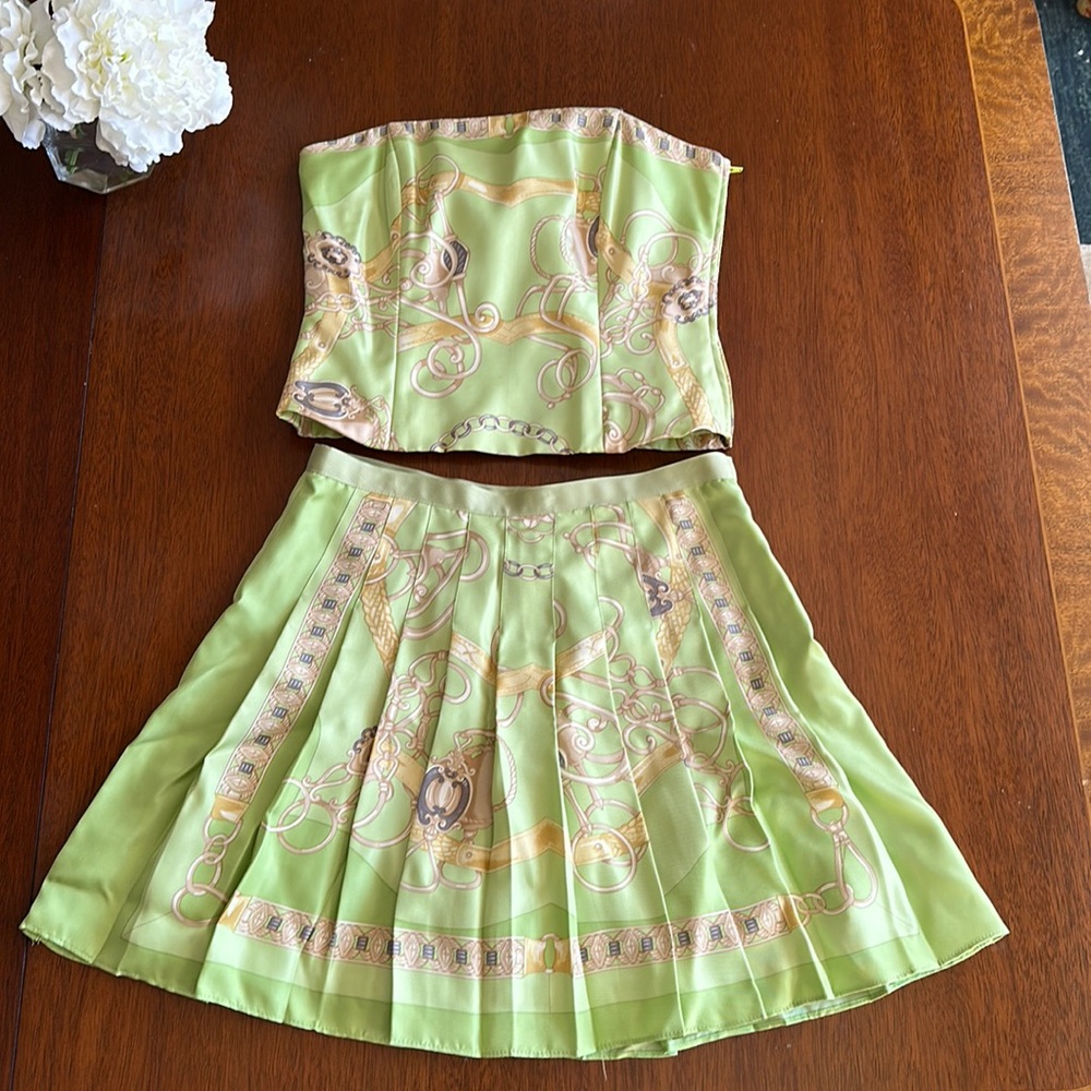 Green w equestrian detail.  Strapless top w pleated mini skirt.